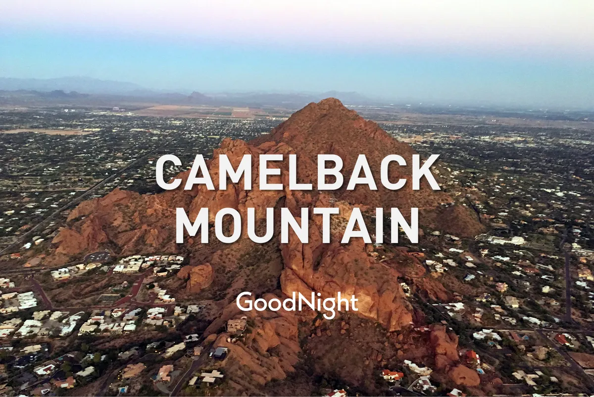 A breathtaking view of Camelback Mountain rising above surrounding residential neighborhoods, with the tranquil landscape inviting outdoor exploration. The composition captures the allure of hiking opportunities and proximity to natural attractions.