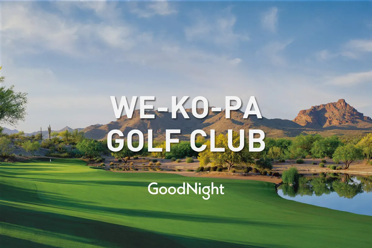 This image captures a pristine golf course surrounded by lush greenery, a tranquil water feature, and a striking mountain backdrop. The serene setting includes inviting fairways and reflective water, evoking the natural beauty and relaxation associated with top-tier golfing experiences in Scottsdale.